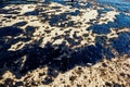 Texture of crude oil spill on sand beach from oil spill accident, Agios Kosmas bay, Athens, Greece, September 14 2017.