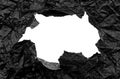 Texture of crumpled black crumpled paper with a hole in the center. Paper with free space for writing Royalty Free Stock Photo