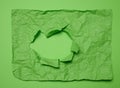 Texture of crumpled green paper with torn hole and green background, template for designer Royalty Free Stock Photo