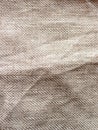 The texture of a crumpled natural linen beige grey color fabric texture background Royalty Free Stock Photo