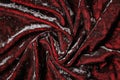 Texture of crumpled velvet fabric, spiral waves of dark red velvet background Royalty Free Stock Photo