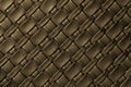 Texture of dark brown and bronze leather background with wicker pattern, macro