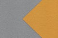 Texture of dark gray paper background, half two colors with orange arrow, macro. Structure of craft grey cardboard