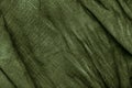 Texture of dark khaki crumpled fabric