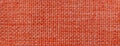 Texture of dark orange background from woven textile material with wicker pattern, macro. Vintage red fabric