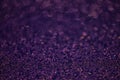 Texture of dark purple glitter dust surface, luxury background with bokeh Royalty Free Stock Photo