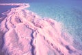 Seascape in pink light, texture of Dead sea. Salty sea shore Royalty Free Stock Photo