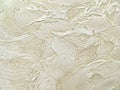 Texture decorative beige plaster imitating the old peeling wall. Royalty Free Stock Photo