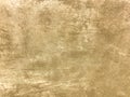 Texture decorative light beige plaster imitating old peeling wall. Obsolete cracked golden stone background with pattern Royalty Free Stock Photo