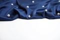 Texture of delicate dark blue silk with pearls on white background Royalty Free Stock Photo