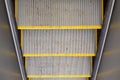 Texture, Dirty old Escalator steps with yellow stripes. top view and metall walls Royalty Free Stock Photo