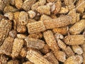the texture of dried corn cakes that have piled up in the cornfield