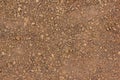 Texture of dry red clay with stones close-up. Royalty Free Stock Photo