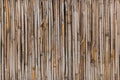 The texture of the dry reeds, fence, roofing material.