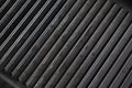 Texture of empty black cast heavy iron grill pan, modern kitchen equipment Royalty Free Stock Photo