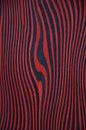 The texture of an exotic wood. Red background with black stripes.