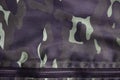 Texture of fabric with a camouflage painted in colors of the marsh. Army background image. Textile pattern of military camouflage Royalty Free Stock Photo