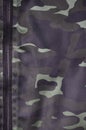 Texture of fabric with a camouflage painted in colors of the marsh. Army background image. Textile pattern of military camouflage Royalty Free Stock Photo