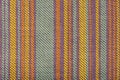 Texture of fabric for furniture upholstery in multicolored vertical stripes. Wear-resistant fabric for furniture in red Royalty Free Stock Photo