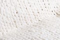The texture of fabric thick beige sweater close-up. Knitted texture background