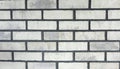 The texture of the facing bricks is white with a rough black grout for mocap. Photo of a wall lined with white bricks in the loft Royalty Free Stock Photo