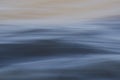 Texture of fast moving water, in gray and yellowish tones Royalty Free Stock Photo