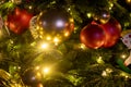 Texture fir branch with lights and decorations toys. a fragment of the New Year and Christmas tree. close-up, soft focus, blur Royalty Free Stock Photo