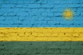 Texture of a flag of Rwanda on a brick wall.