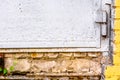 Detail of old damaged white painted metal door Royalty Free Stock Photo