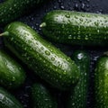 The texture of fresh green delicious zucchini with large drops of water, close-up, a good background for advertising vegetables,