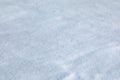 Texture of fresh snow covering ground thickly on frosty winter morning. Shallow DOF