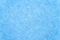 The texture of a frozen window in snowflakes and a blue ice pattern. Winter background Royalty Free Stock Photo