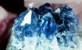 Texture of gemstone cluster closeup as a part of geode filled with rock blue Amethyst crystals. Royalty Free Stock Photo