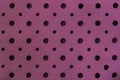 Texture of genuine geometric perforated genuine leather close-up, trendy purple color