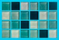 The texture of glass tiles with square elements of blue shades. Blue, white and turquoise squares on a light blue background Royalty Free Stock Photo