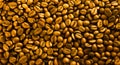 Texture of golden coffee beans, background close-up. Royalty Free Stock Photo