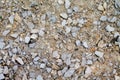 Texture gravel in its natural state with sand as background.