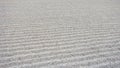 Texture of gravel that is raked in waves of straight lines