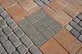 Texture of gray and brown paving slabs on the street, perspective view. Cement brick square stone floor background Royalty Free Stock Photo