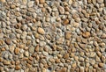 Texture of a gray concrete wall with small brown rounded stones Royalty Free Stock Photo