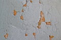 Texture of a gray cracked wall. Old yellow paint can be seen on the wall Royalty Free Stock Photo