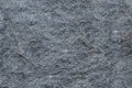 Texture gray granite rough untreated natural stone with white impregnations background natural Royalty Free Stock Photo