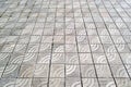 Texture of gray square concrete paving slabs with a stylized wave ornament. Paving slabs with a diagonal pattern Royalty Free Stock Photo