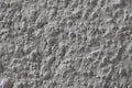 The texture of the gray wall. Decorative plaster. Rough grainy bumpy surface. Royalty Free Stock Photo