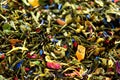 Texture of green tea with dried petals of blue flowers, calendula, cornflower. Food background. Organic healthy herbal