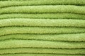 Texture of green towel close-up. A stack of soft bath accessories