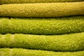 Texture of green towel close-up. A stack of soft bath accessories