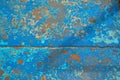 The texture of the iron metal painted blue paint old battered scratched cracked ancient rusty metal sheet wall with corrosion. Royalty Free Stock Photo