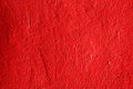 The texture of an iron metal painted bright red scarlet peeling paint old battered scratched cracked ancient Royalty Free Stock Photo