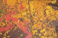 Texture of iron metal painted multicolored red yellow peeling paint of old battered scratched cracked ancient rusty metal sheet Royalty Free Stock Photo